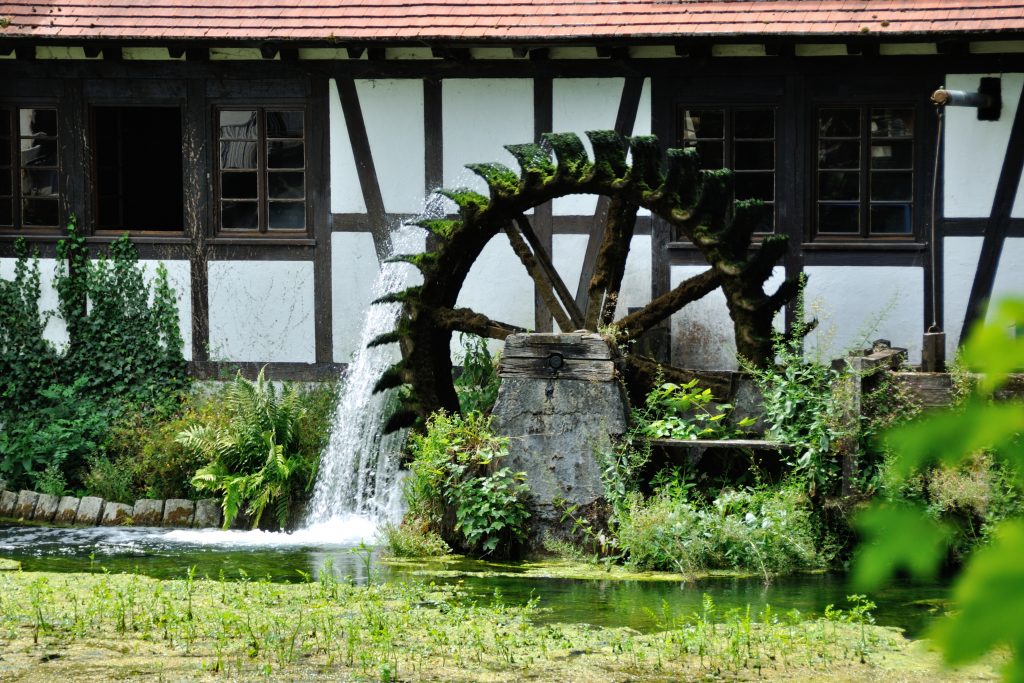 Historisches Wasserrad an einer alten Mühle in ländlicher Umgebung